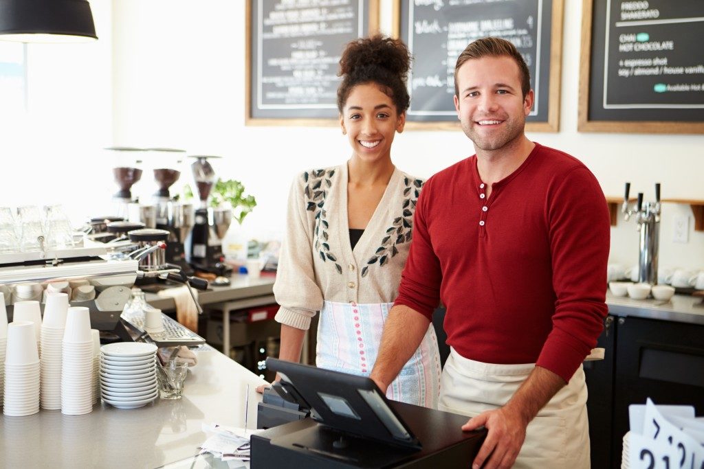 Man and woman managing a coffee shop