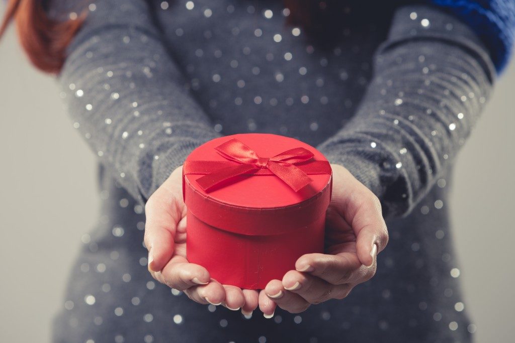 woman holding a red gift box
