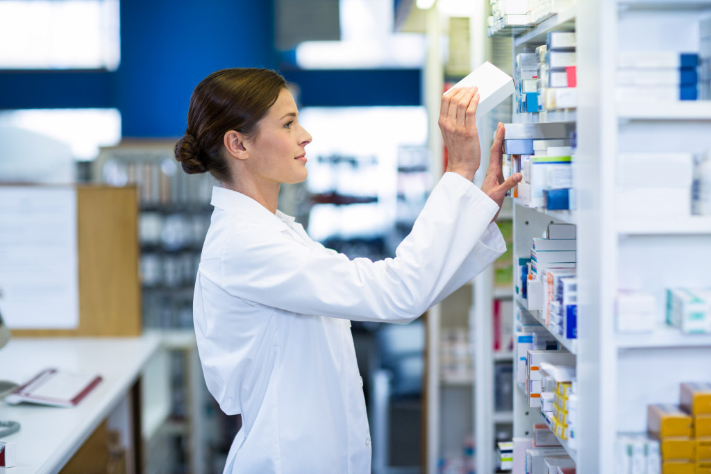a female pharmacist stocking shelves