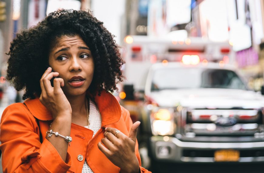 A woman worriedly taking a phone call about her home while in another city