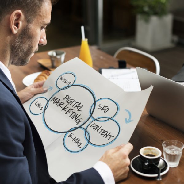 man looking at the paper with digital marketing writing