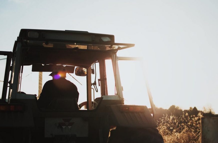 silhouette of a farmer riding a tractor
